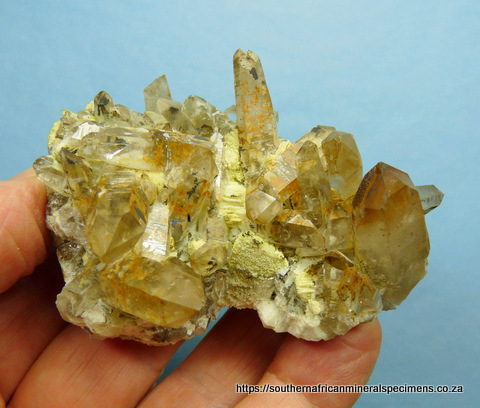 Quartz crystal group with hematite and feldspar