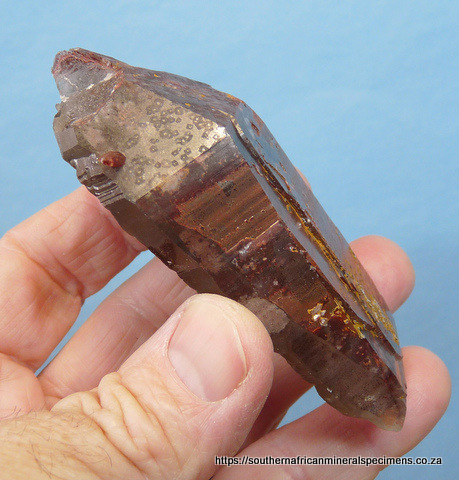 Flattish quartz crystal with hematite inclusions