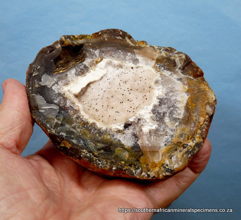 Agate geode lined with chalcedony and unknown specks
