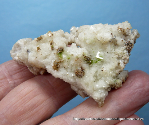 2-sided calcite specimen with bits of duftite
