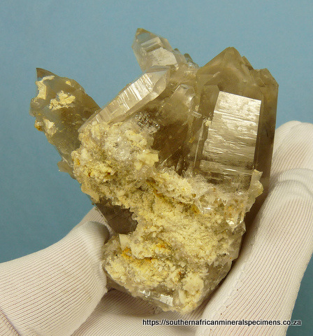 Light smoky quartz crystal group with rutile
