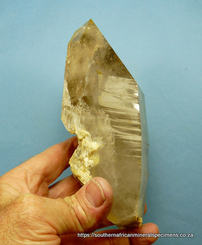 Large, light smoky quartz crystal with several rutile inclusions, and feldspar
